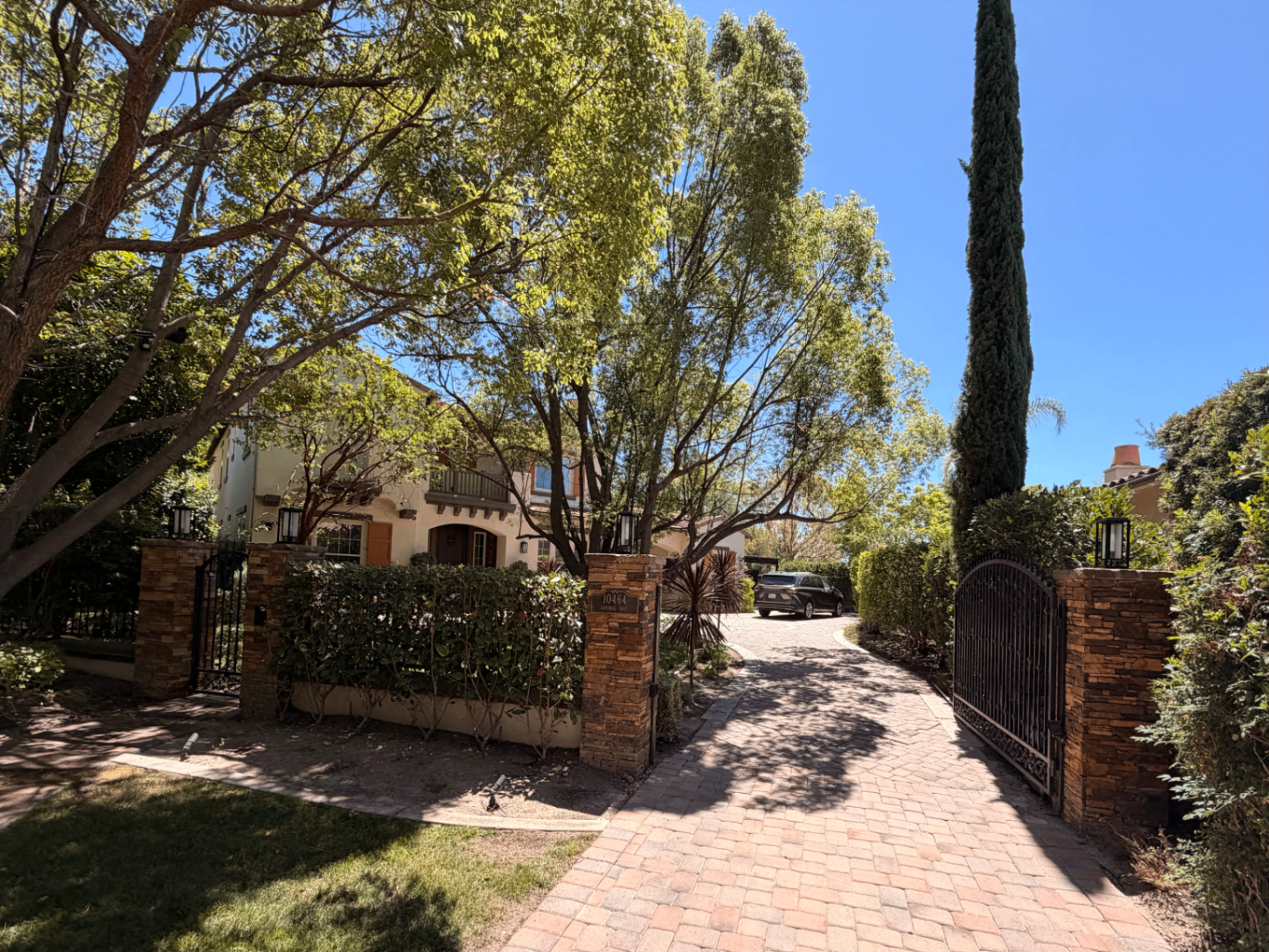 Private gated paver driveway and stone pillars at 10464 Caribou Way
